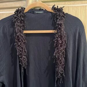 Women’s black button up sweater with frilly neckline